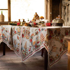 Tovaglia natalizia Noel Gourmand in puro lino di Tessitura Toscana Telerie. Fantasia su fondo chiaro, con scene che ritraggono dolci natalizi e tavole imbandite nel periodo di Natale. Le scene ritratte sono ricche di dettagli e fanno respirare aria di festa. La fantasia è incorniciata da una riga rossa e da una ghirlanda di biscotti a tema natalizio. Misura rettangolare x12 (170x270 cm).