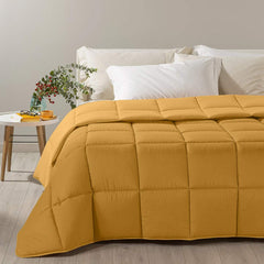 Trapunta invernale Caleffi Tinta Unita Double in microfibra. Piumone double face colore giallo oro ocra