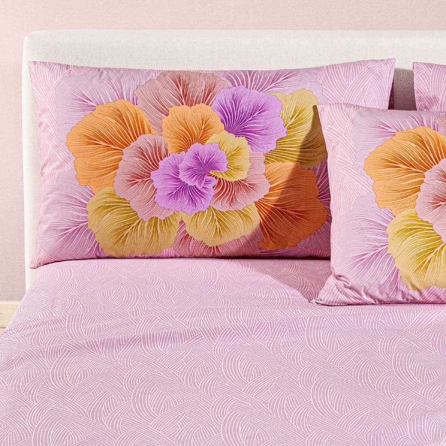 completo lenzuola madreperla caleffi. Federe con grande fiore rosa e arancio. Lenzuola con fantasia rosa a intrecci