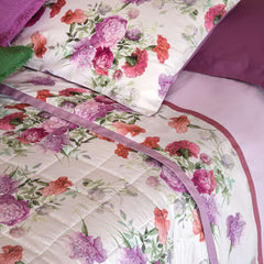 Completo lenzuola matrimoniale Fazzini Summer, in percalle e raso di puro cotone. La fantasia Summer è ispirata dalla bellezza del garofano. Il disegno romantico e vivido dei fiori decora le federe e la balza superiore del lenzuolo di sopra, entrambe in raso di cotone. Colore rosa glicine. La fantasia è presente sulla faccia superiore delle federe e sulla balza del lenzuolo di sopra, entrambe in raso di cotone. Il resto del completo è in percalle tinta unita rosa.