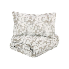 Copripiumino matrimoniale Fazzini Lunaria, in percalle di puro cotone. Il copripiumino Lunaria presenta una fantasia floreale dallo stile moderno, con fiori chiari su fondo grigio. Il set include un sacco copripiumino e due federe