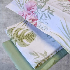 Lenzuolo copriletto matrimoniale Atelier 35, di Tessitura Randi, in percalle di puro cotone. Romantica fantasia floreale con foglie e fiori su fondo chiaro. La fantasia è presente sul lenzuolo di sopra e sulle federe. Il risvolto del lenzuolo di sopra è stampato, essendo un lenzuolo copriletto. Il lenzuolo con angoli è in tinta unita verde