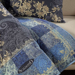 Scaldotto Caleffi Berry. Fantasia con piante e uccelli su fondo blu notte e bordo patchwork. Plaid in cotone caldo.