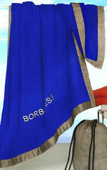 Telo mare Borbonese Mykonos con sacca porta telo. Telo mare tinta unita in spugna di puro cotone, discreto e raffinato, bordato e con logo ricamato. Colore bluette.
