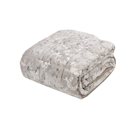 Trapunta Invernale matrimoniale Fazzini Boboli in percalle di puro cotone. Su uno sfondo in raffinata tinta unita, i petali si animano e diventano tridimensionali in un'interpretazione contemporanea delle atmosfere romantiche. Piumone fantasia floreale torrone beige.