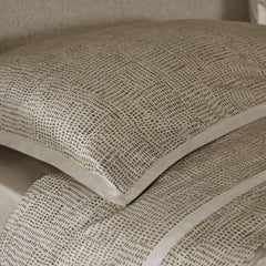 Trapuntino matrimoniale Pirellone, della linea Fazzini Atelier, in raso di puro cotone. La fantasia minimal dall'effetto traslucido del quilt Pirellone rivela una texture chiaramente contemporanea, che nella camera da letto diventa importante elemento di arredo. La trapunta primaverile Pirellone è trapuntata a capo e rifinita a mano con due angoli sagomati che la adattano perfettamente agli angoli del letto