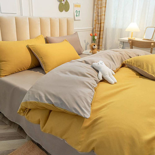 Parure copripiumino tinta unita double face, in 100% puro cotone. Il set include un sacco copripiumino e una federa bicolori. Colore giallo ocra e grigio