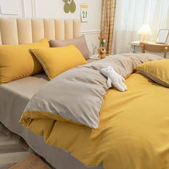 Parure copripiumino tinta unita double face, in 100% puro cotone. Il set include un sacco copripiumino e una federa bicolori. Colore giallo ocra e grigio