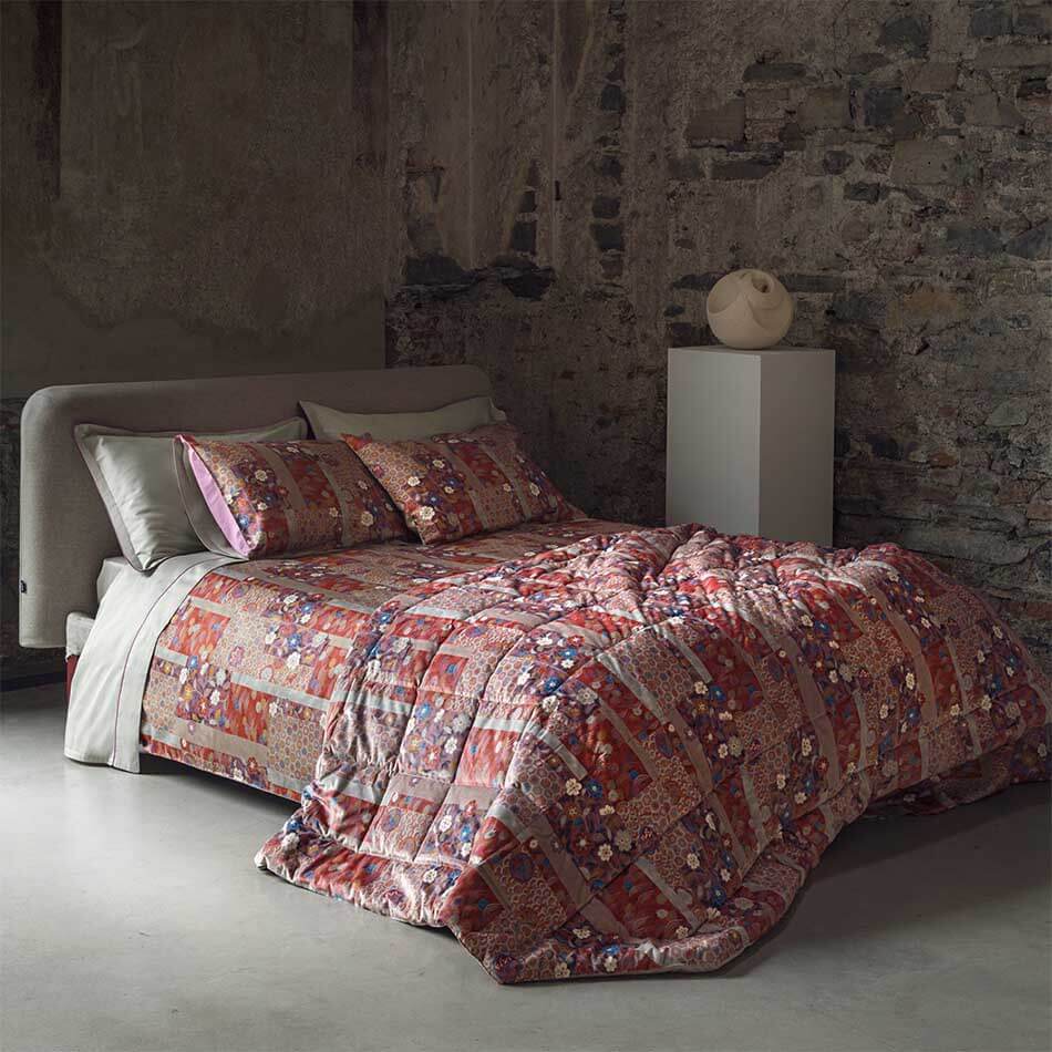 Copripiumino matrimoniale Fazzini Kiyomi in raso di puro cotone. Caratterizzato da originale fantasia floreale d'ispirazione giapponese stampata in digitale. Colore rosso, grigio, viola con fiori colorati.