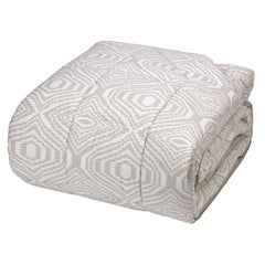 Trapunta invernale Fazzini Plops in percalle di puro cotone. Disponibile nella misura matrimoniale e piazza e mezza. Moderna fantasia geometrica colore bianco/beige