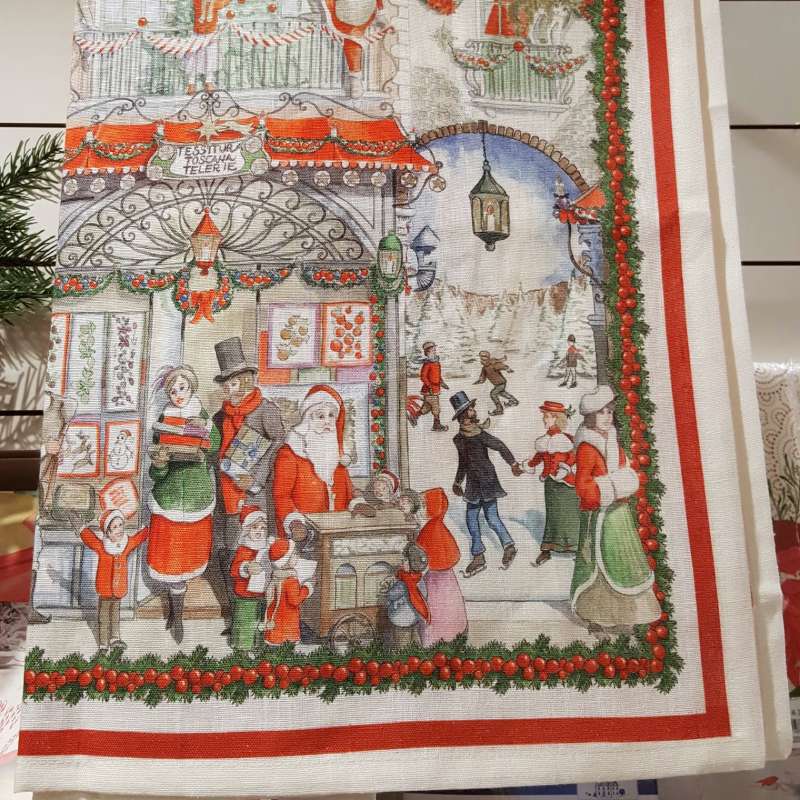 Corsia natalizia Christmas Shopping di Tessitura Toscana in puro lino. Il runner Christmas Shopping presenta una fantasia su fondo chiaro, con scene di shopping ricche di dettagli e che richiamano vari elementi tipici del Natale, come gli abeti addobbati, Babbo Natale, i negozi illuminati e le ghirlande. Misura: 45x170 cm