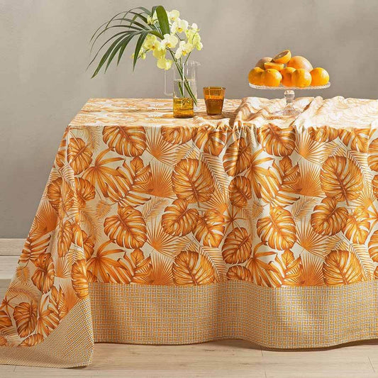 Telo Arredo multiuso Foglie di Caleffi, in puro cotone. Fantasia con bordo geometrico e foglie stampate sul resto del telo. Colore arancio.