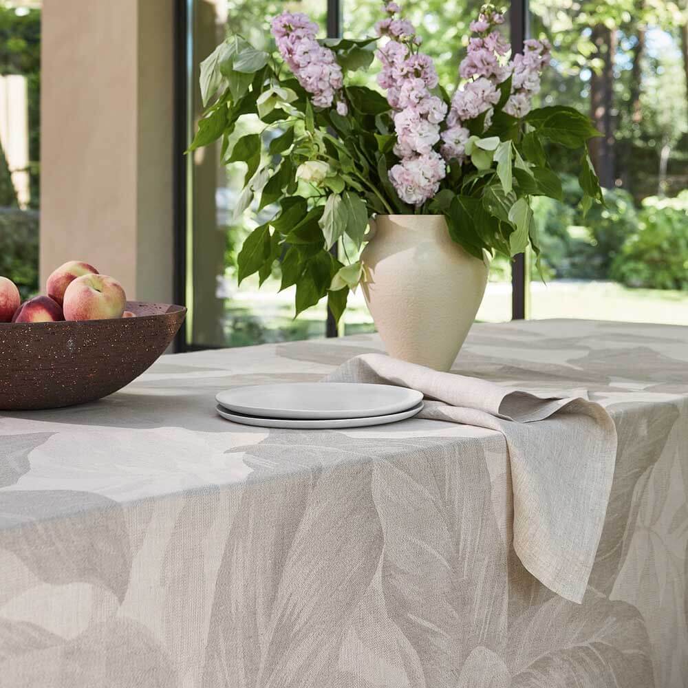 Tovaglia Foliage di Fazzini, misura rettangolare per 12 persone. Fantasia con foglie color beige tortora. Composizione 65% lino, 35% cotone.