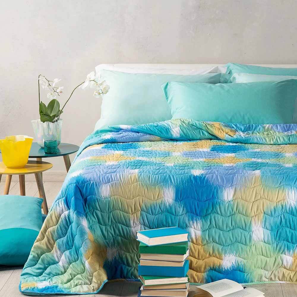 Trapuntino Caleffi Murano in microfibra. Trapunta primaverile caratterizzata da una fantasia moderna, con macchie multicolor stile acquerello, colore bluette verde acqua. Disponibile nella misura per letto singolo, piazza e mezza e matrimoniale.