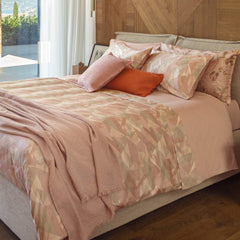 Lenzuolo copriletto matrimoniale Fazzini Symphonic, in percalle di puro cotone. Il completo lenzuola Symphonic presenta una moderna fantasia geometrica colore rosa. La fantasia è presente sulla faccia superiore delle federe e sul lenzuolo di sopra. Anche la balza del lenzuolo di sopra è stampata, essendo un lenzuolo copriletto. Il resto del completo è in percalle di cotone tinta unita  rosa