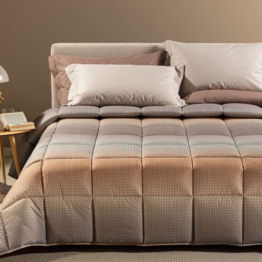 Trapunta invernale Caleffi Larry. Piumone con fantasia geometrica degradè grigio e gold.