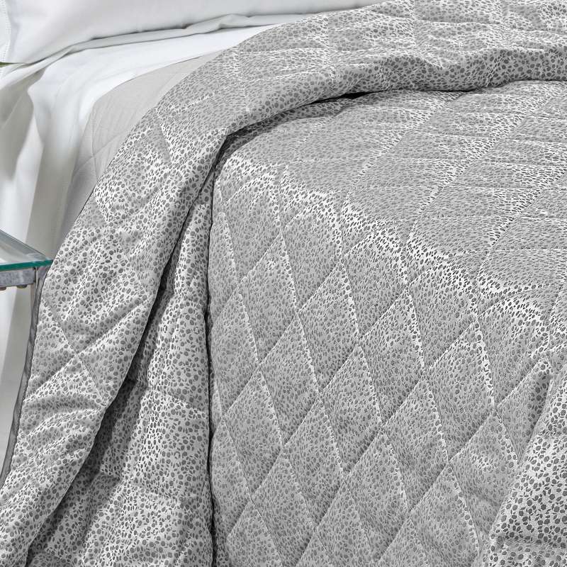 Trapuntino matrimoniale Caleffi Perleè, in elegante raso jacquard.La trapunta primaverile Perleè è caratterizzata da una fantasia geometrica moderna a puntini, colore grigio