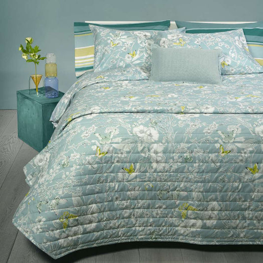 trapuntino fazzini Farfalle. fantasia con fiori bianchi e farfalle verdi su fondo tinta unita petrolio