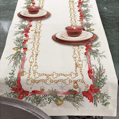 Corsia natalizia Charms di Tessitura Randi. Stampata in digitale su tessuto di puro cotone.  Runner in fantasia, fondo avorio con particolari catenine dorate ed elementi tipici del Natale come ghirlande e fiocchi rossi.  Misura: 50x150 cm