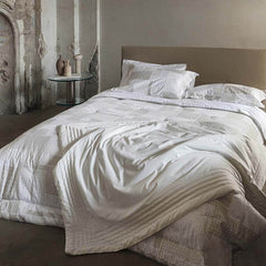 Trapunta invernale matrimoniale Cristalli di Fazzini in raso di puro cotone. Piumone medio tepore. Fantasia geometrica colore bianco seta/avorio/beige.