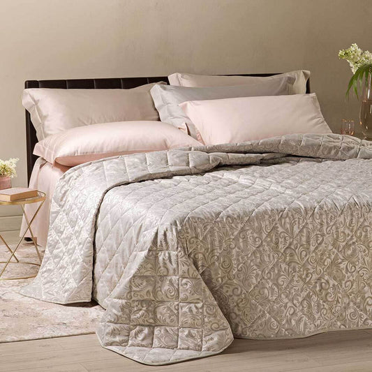 Trapuntino matrimoniale Caleffi Astoria in raso jacquard. Fantasia elegante che abbina elementi floreali a elementi grafici dalle forme morbide. Colore beige.